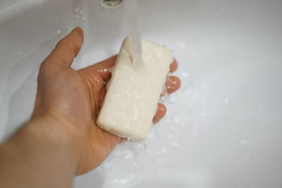 Close-up of hand holding ice cream