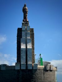 Low angle view of statue against sky