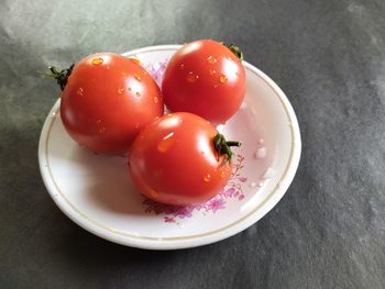 High angle view of tomatoes in plate on table