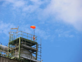 Low angle view of red balloon against blue sky