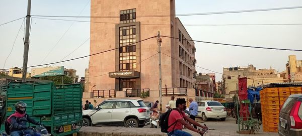 Cars on street amidst buildings in city