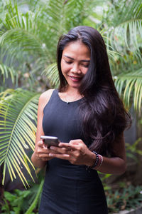 Portrait of woman holding smart phone