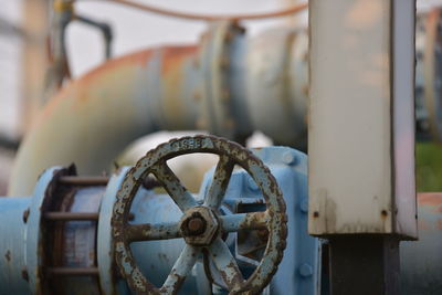 Close-up of rusty machine part in factory