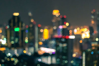 Defocused image of illuminated city at night