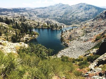 High angle view of lake and mountains against sky