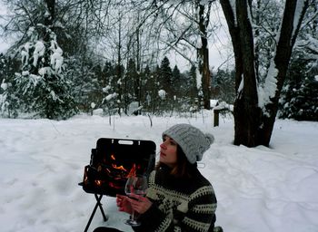 Man photographing camera on snow covered land