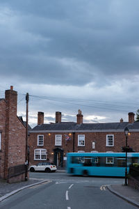 Cars on street against sky