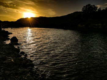 Scenic view of lake against sky during sunset