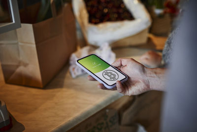 Person paying with bitcoin crypto currency for groceries