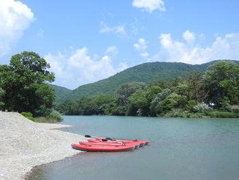 Boat in river against sky