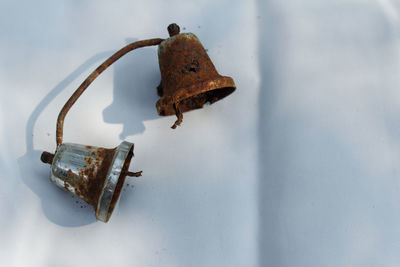 Close-up of abandoned lamp on wall