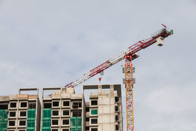 Low angle view of crane against sky