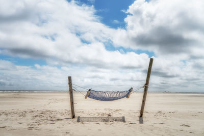 A hammock in the middle of a wide beach on the island of amrum