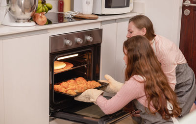 Rear view of woman preparing food in kitchen