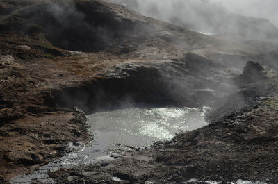 Boiling, bubbling and steaming mud in a volcanic landscape.
