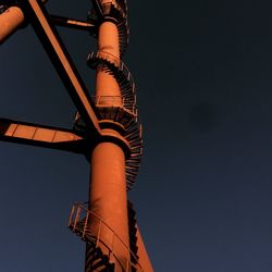 Low angle view of crane against clear sky