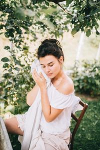 Young woman sitting outdoors