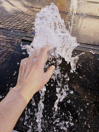 High angle view of woman hand in water