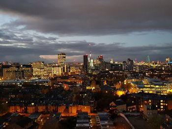 High angle view of illuminated city buildings against sky