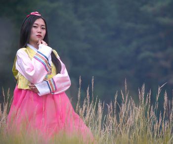 Girl looking away while standing on field