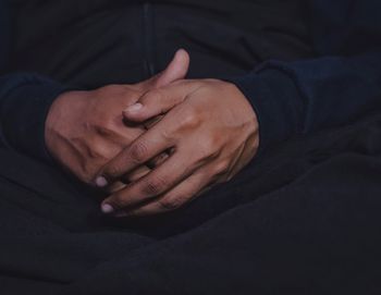 Close-up midsection of man hands in darkroom