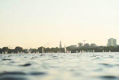 View of river and buildings against clear sky