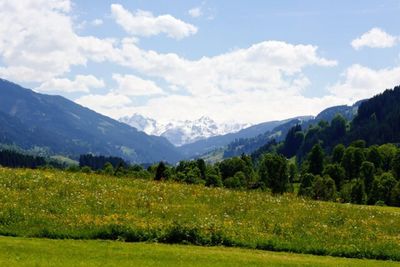 Scenic view of mountains against cloudy sky