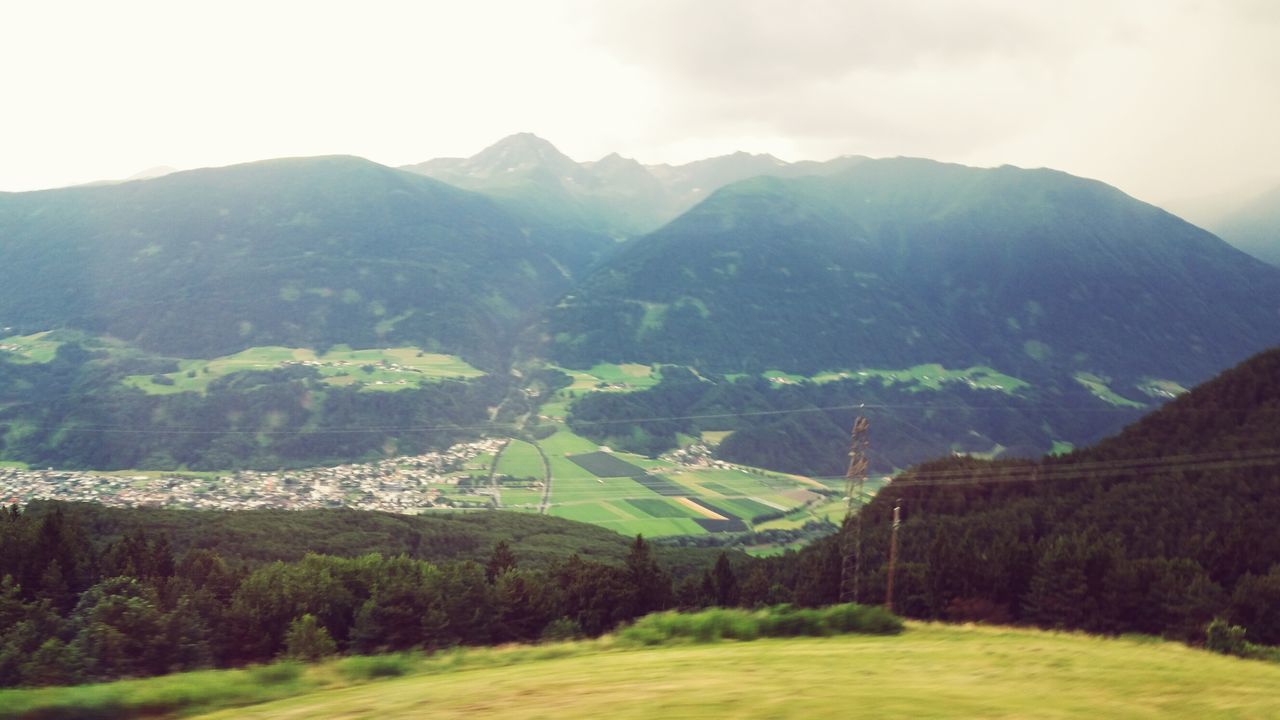 mountain, mountain range, tranquil scene, landscape, tranquility, scenics, beauty in nature, green color, nature, sky, non-urban scene, tree, idyllic, grass, valley, hill, remote, growth, countryside, day, lush foliage, green, outdoors, no people, rural scene, non urban scene, majestic, cloud - sky, cloud, weather, grassy, travel destinations