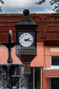 Low angle view of clock on wall