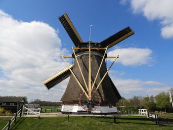 Low angle view of windmill against sky