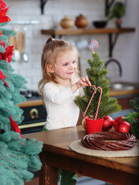 Portrait of cute girl sitting on table