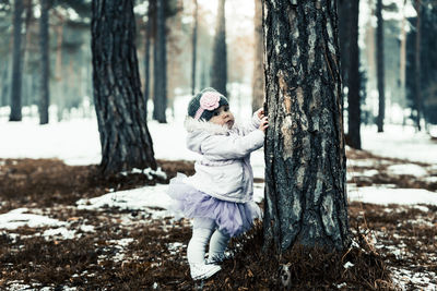 Man wearing tree trunk in forest