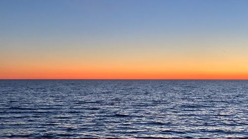 Scenic view of sea against clear sky during sunset