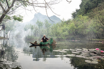 Man kayaking in lake