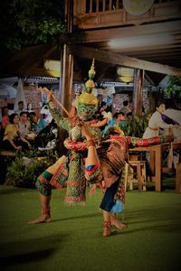 Group of people dancing at music concert