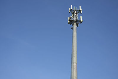 Low angle view of communications tower against sky