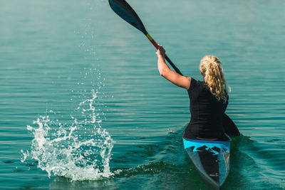 Rear view of woman by sea