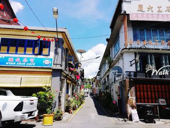 Street amidst buildings against sky in city