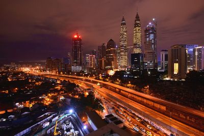 High angle view of city lit up at night