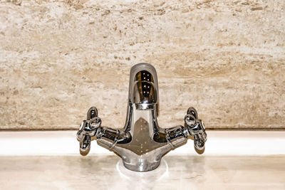 Close-up of plumbing faucet mixer at home