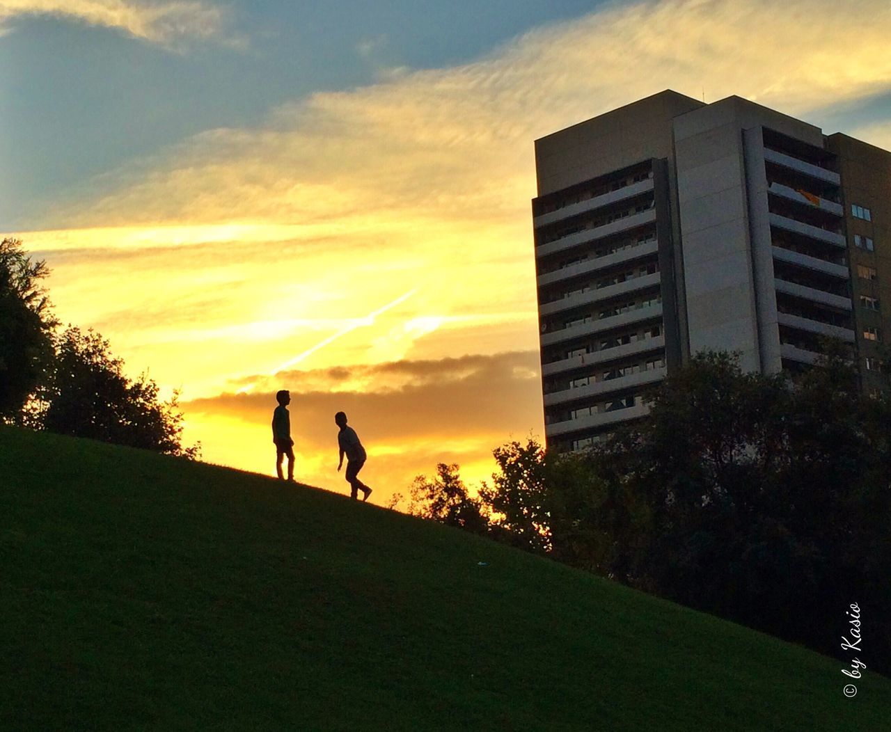 sunset, building exterior, silhouette, architecture, sky, orange color, built structure, tree, men, cloud - sky, lifestyles, cloud, nature, outdoors, leisure activity, walking, beauty in nature, yellow, building