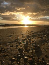 Scenic view of beach against sky during sunset