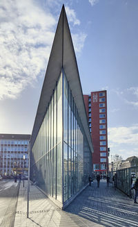 View of modern building against cloudy sky