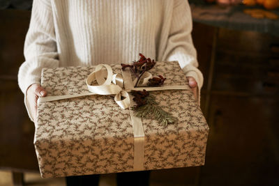 Woman holding wrapped christmas present