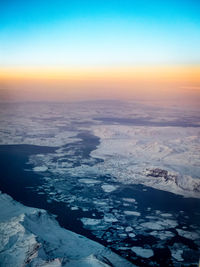 Scenic view of landscape against blue sky during sunset