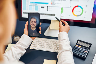 Midsection of woman using laptop on table