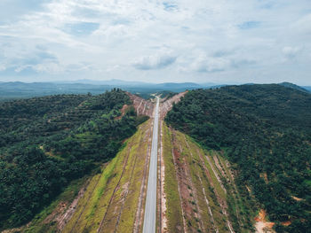 High angle view of road amidst trees against sky