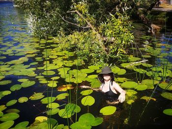 Portrait of young man floating on water in lake