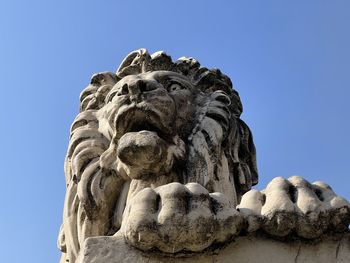 Low angle view of statue against clear blue sky