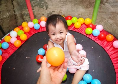 High angle view of cute girl holding balloons